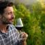A man holding a wine glass at a wine tasting.